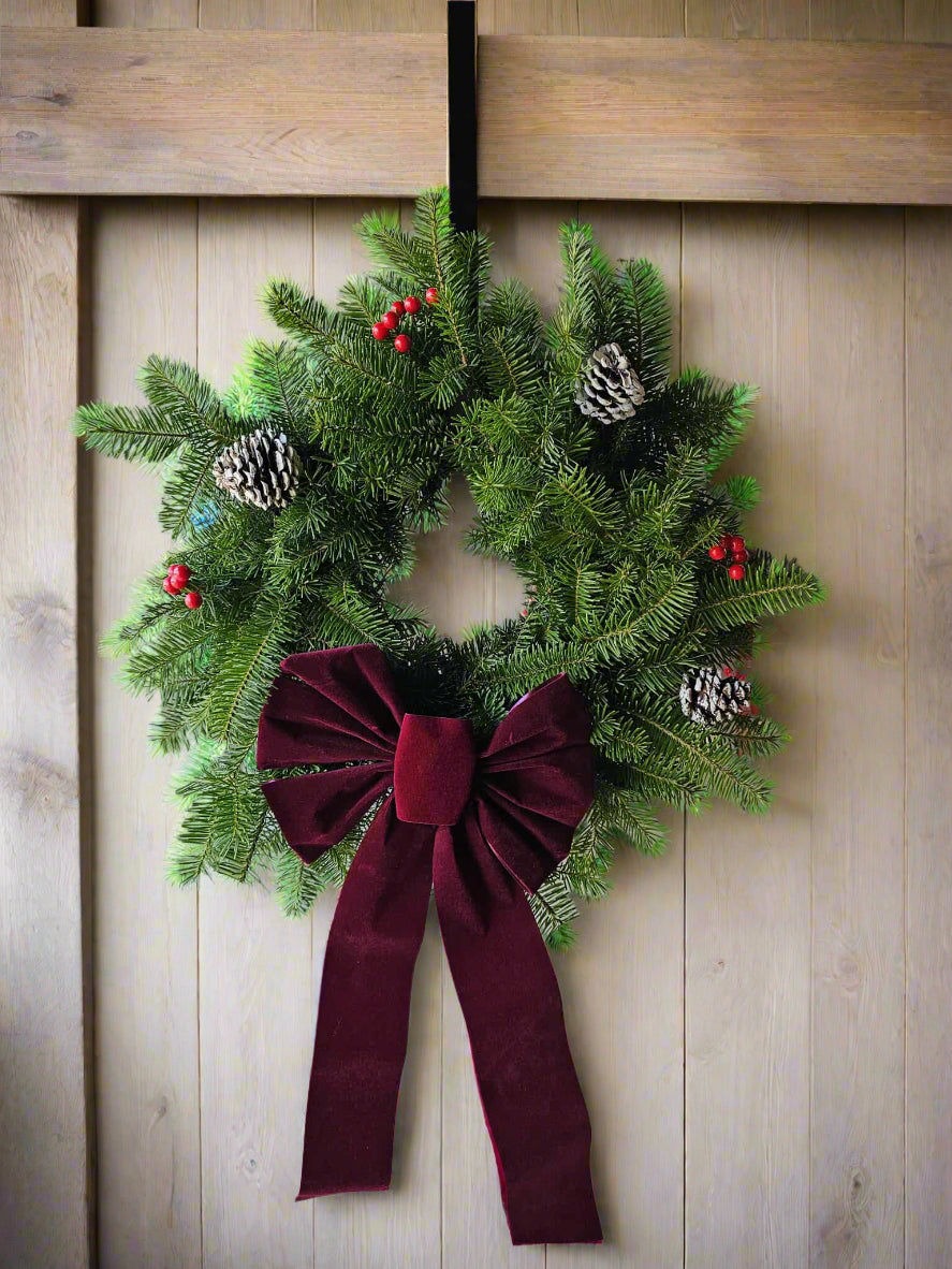 Christmas wreath with a red bow on a door